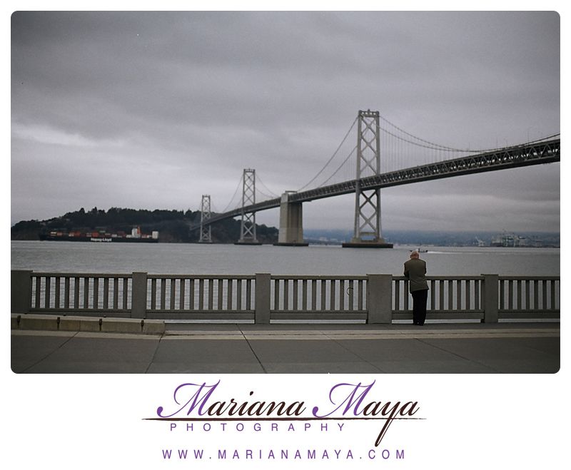 man looking at the Bay Bridge, San Francisco, CA 